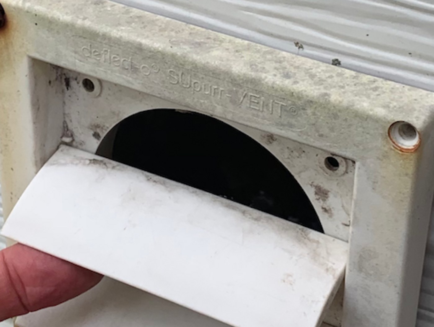 Exterior dryer vent outlet on residential siding